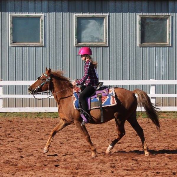 a person riding a horse in front of a building