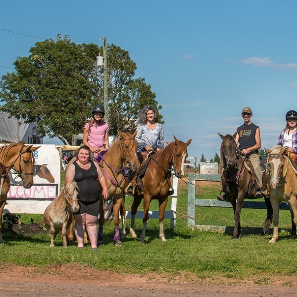 a group of people riding on the back of a horse