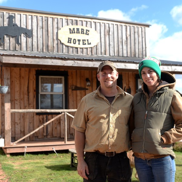 a man and a woman standing in front of a building