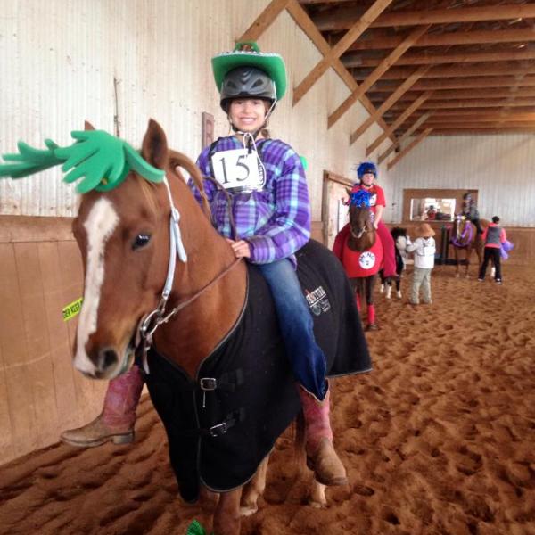 a person standing next to a brown horse