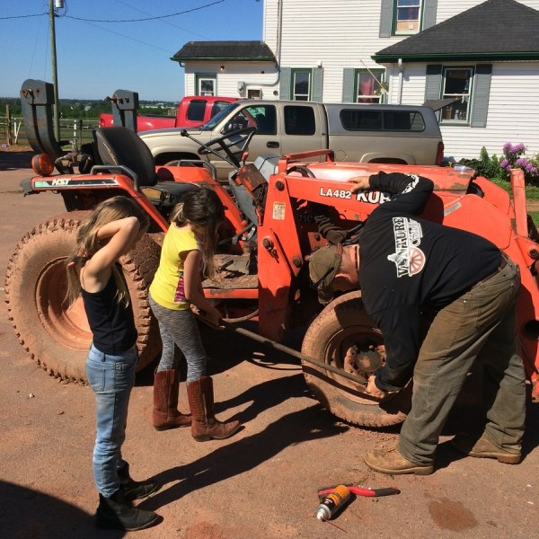 a group of people standing next to a truck