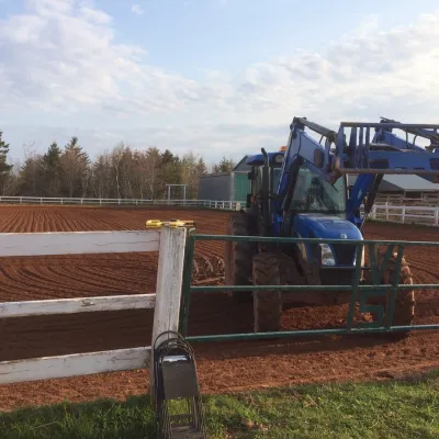 a person sitting on top of a wooden fence