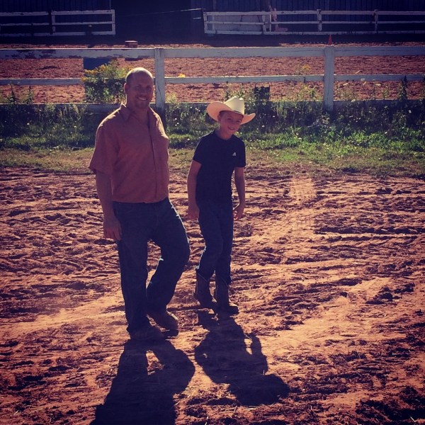a man standing on top of a dirt field