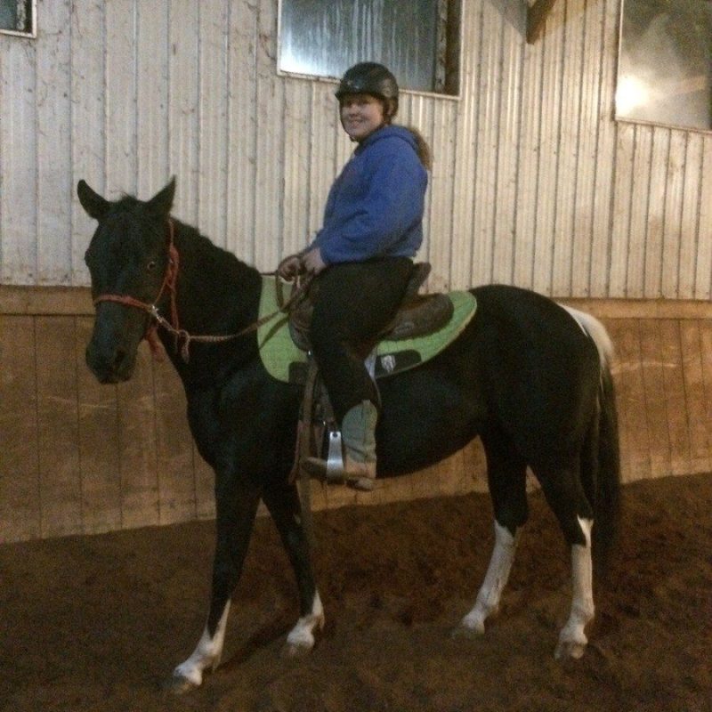 a person on a horse in front of a building