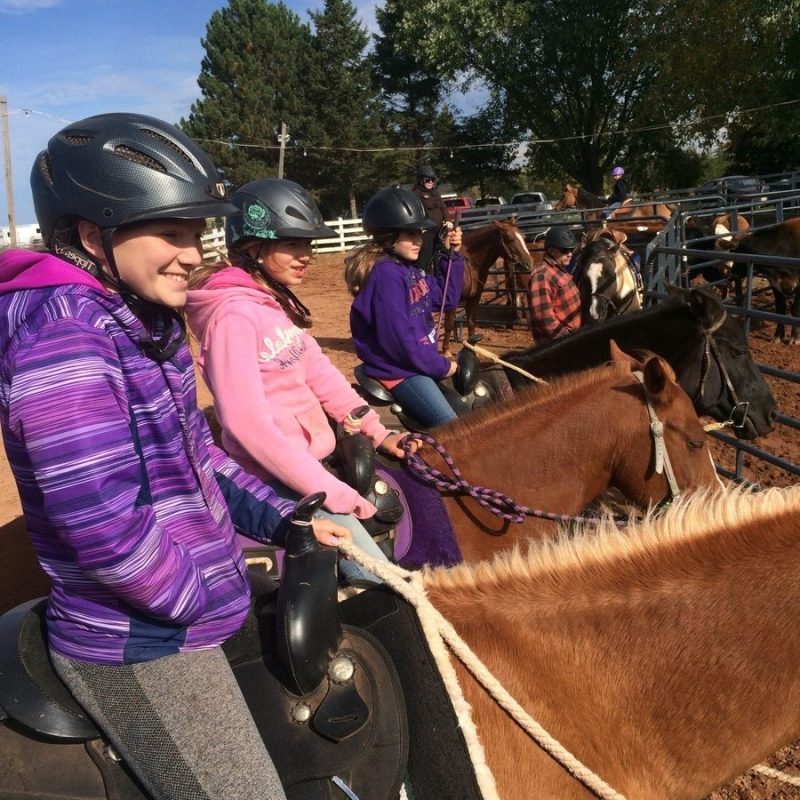 a group of people riding on the back of a horse