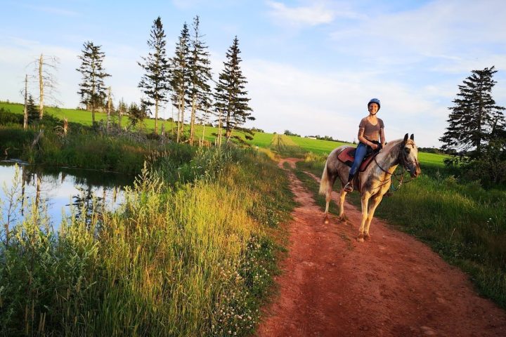 a man riding a bike down a dirt road