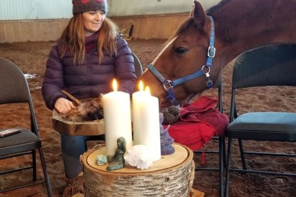 a cat sitting on top of a wooden chair