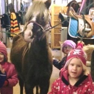 a little girl standing next to a child