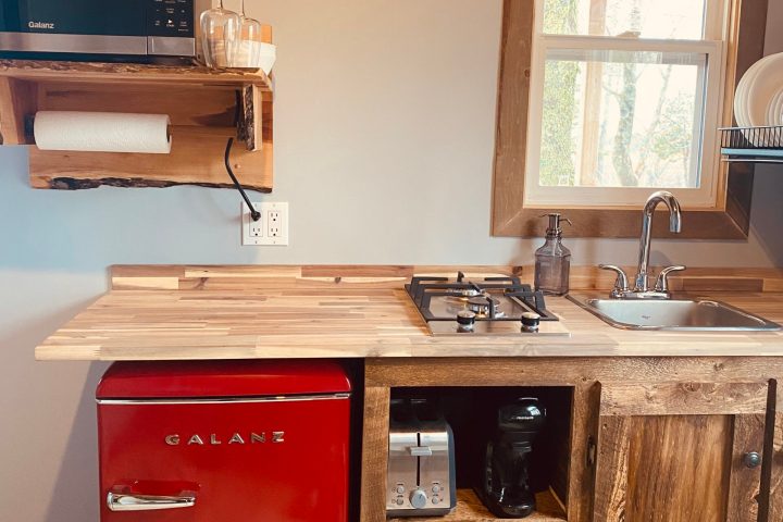 a microwave oven sitting on top of a wooden desk