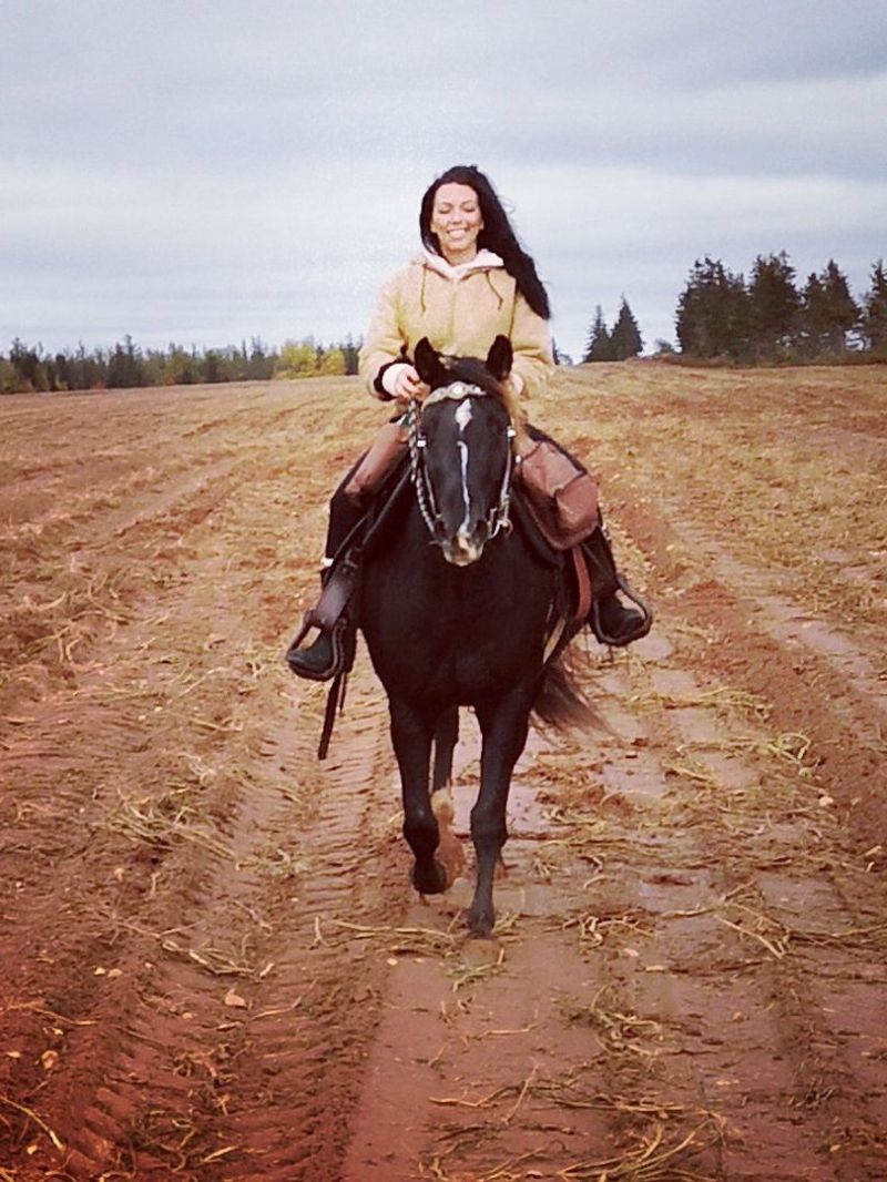 a man riding a horse in a dirt field