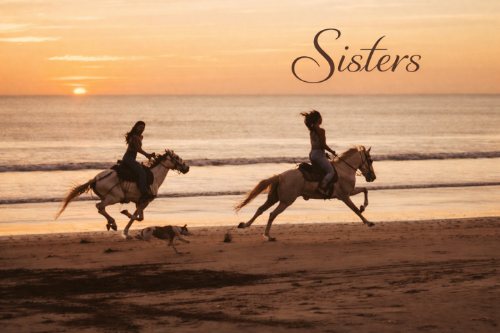 Two women riding horses on a beach at sunset, with text 'Sisters'.